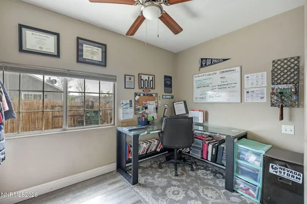 a view of a workspace with furniture and a window