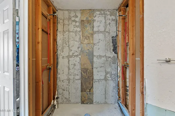 a bathroom with a shower and a glass door