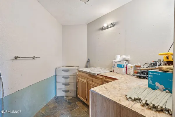 a kitchen with a sink a stove and cabinets