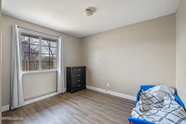 a view of room with hardwood floor and cabinet