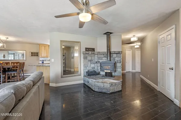 a living room with furniture and a view of kitchen
