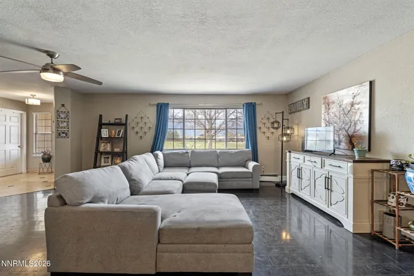 a living room with furniture fireplace and a window
