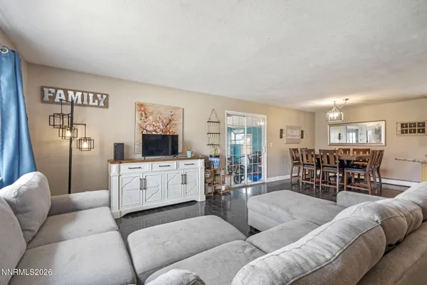 a living room with furniture and kitchen view