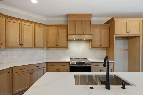 a kitchen with white cabinets and appliances