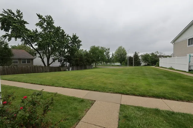a front view of a house with a garden and yard