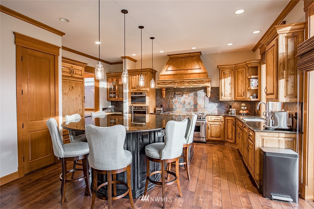 907 North 35th Street Renton, WA 98056 - Photo 12 of 37 a dining room with stainless steel appliances granite countertop a table chairs and a refrigerator
