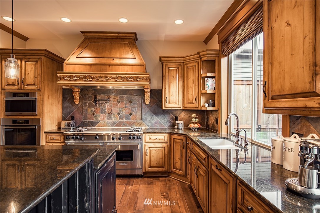 907 North 35th Street Renton, WA 98056 - Photo 13 of 37 a kitchen with stainless steel appliances granite countertop a sink a stove and a refrigerator