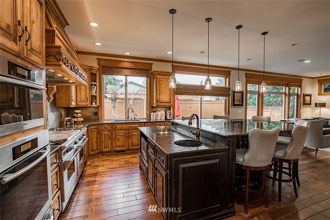 907 North 35th Street Renton, WA 98056 - Photo 15 of 37 a kitchen with stainless steel appliances granite countertop a stove a sink and a microwave