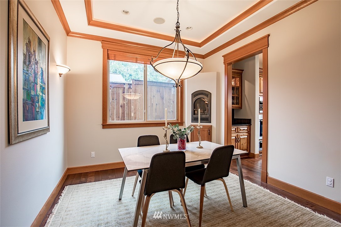 907 North 35th Street Renton, WA 98056 - Photo 17 of 37 a dining room with furniture a chandelier and wooden floor
