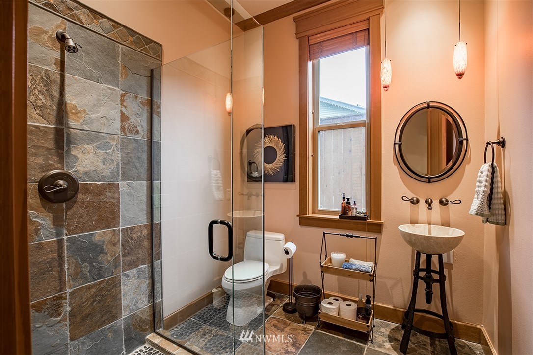 907 North 35th Street Renton, WA 98056 - Photo 21 of 37 a bathroom with a sink a toilet and a mirror