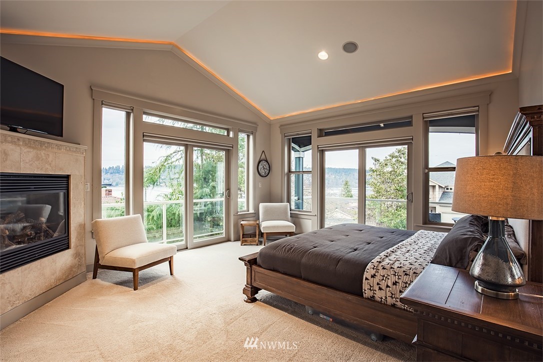 907 North 35th Street Renton, WA 98056 - Photo 24 of 37 a spacious bedroom with a bed and a fireplace