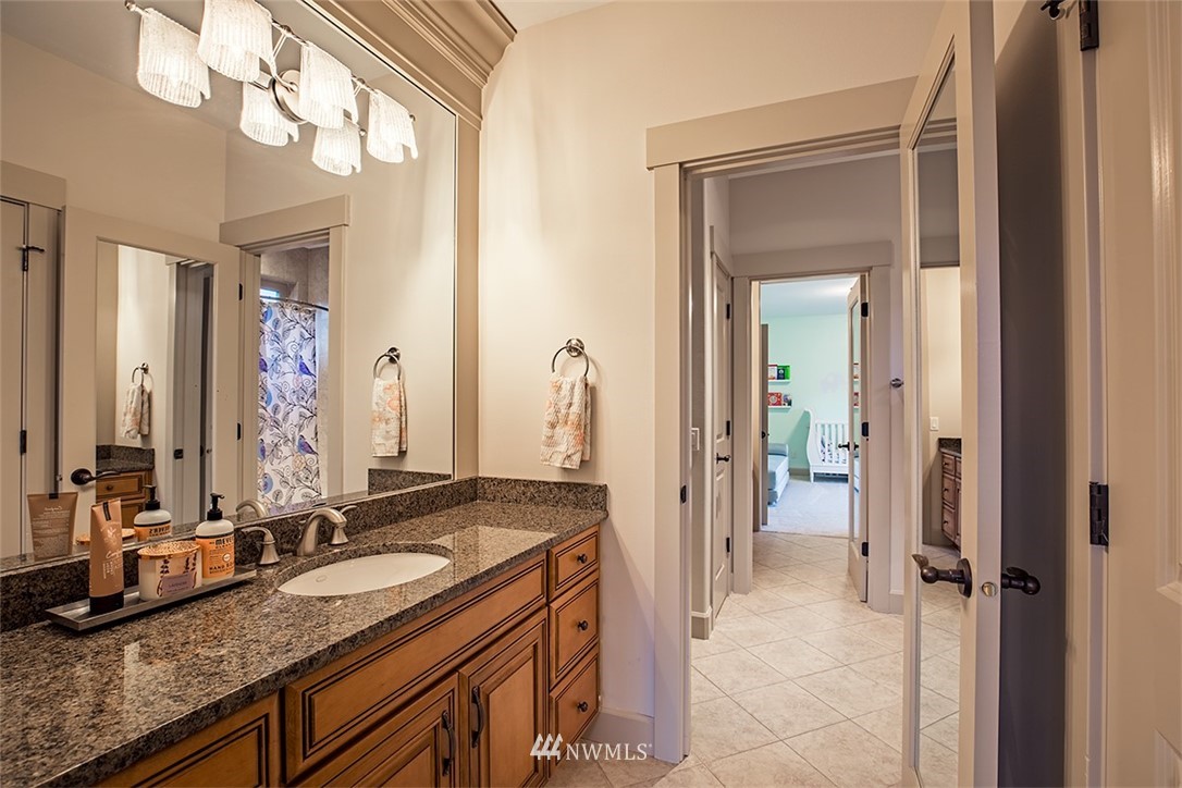 907 North 35th Street Renton, WA 98056 - Photo 29 of 37 a bathroom with a granite countertop sink and a mirror