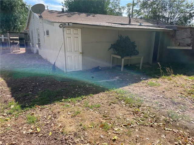 a backyard of a house with table and chairs