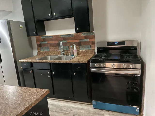 a stove top oven sitting inside of a kitchen