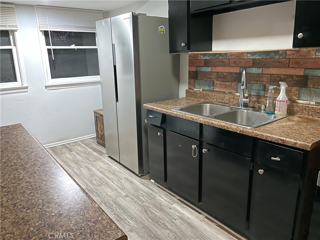 1543 West Orange Grove Avenue Pomona, CA 91768 - Photo 6 of 11 a bathroom with a granite countertop sink and a mirror