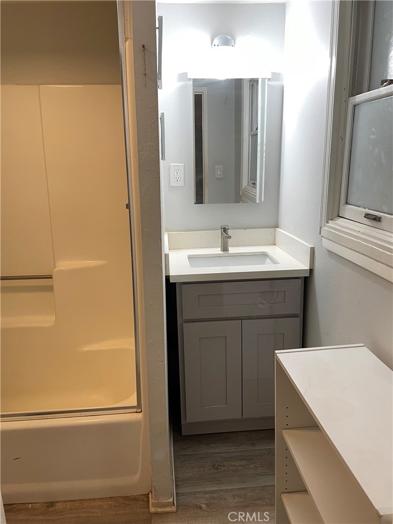 1543 West Orange Grove Avenue Pomona, CA 91768 - Photo 8 of 11 a bathroom with a sink and a mirror