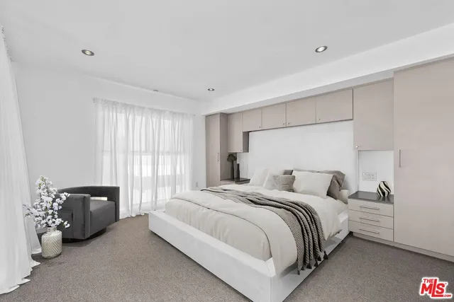 a bedroom with a bed and a couch