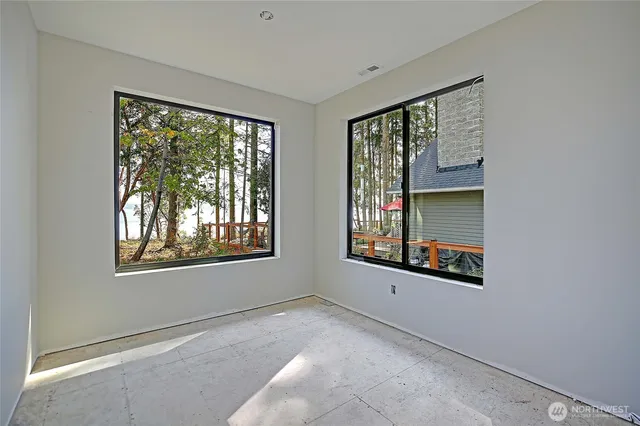 a view of an empty room with a window and fireplace