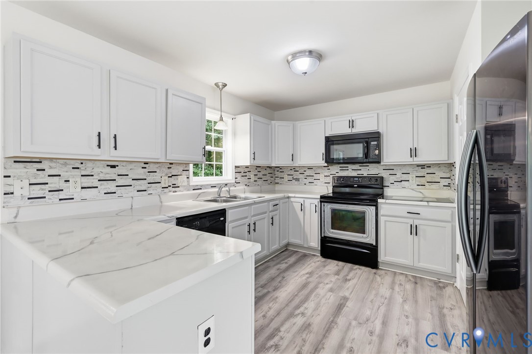 7610 Sugar Run Road Hopewell, VA 23860 - Photo 34 of 48 Kitchen featuring white cabinetry with black hardw