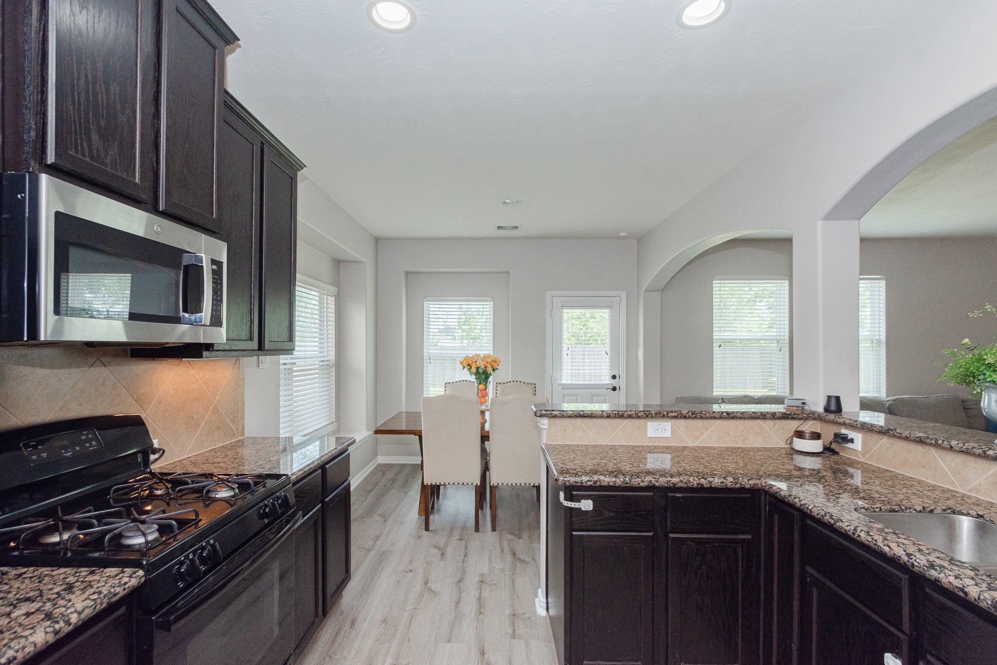 4907 Applewood Crest Lane Rosharon, TX 77583 - Photo 13 of 36 a kitchen with a sink stove and cabinets