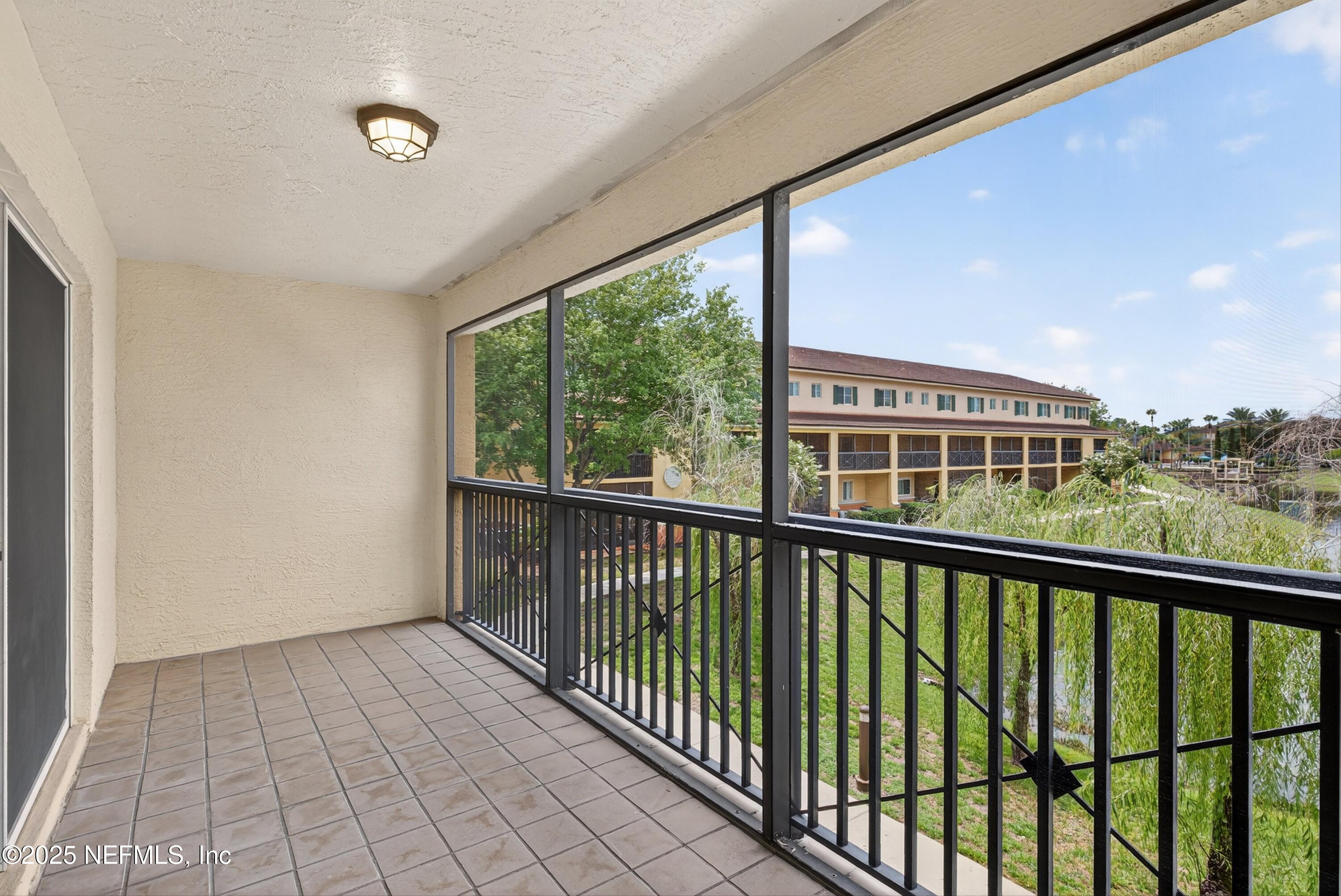 9745 Touchton Road, Unit 1625 Jacksonville, FL 32246 - Photo 22 of 69 a view of balcony with a floor to ceiling window and stairs