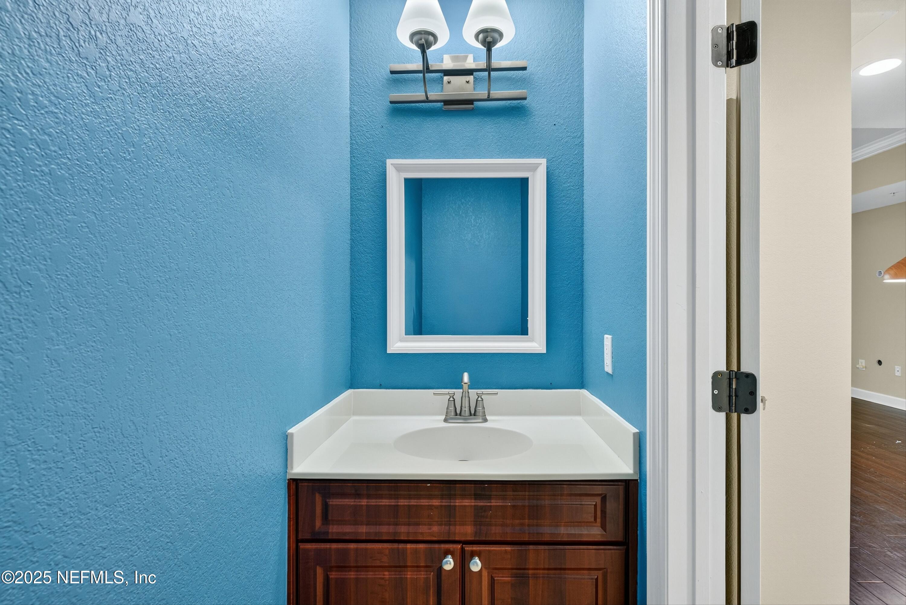 9745 Touchton Road, Unit 1625 Jacksonville, FL 32246 - Photo 27 of 69 a bathroom with a sink and a mirror