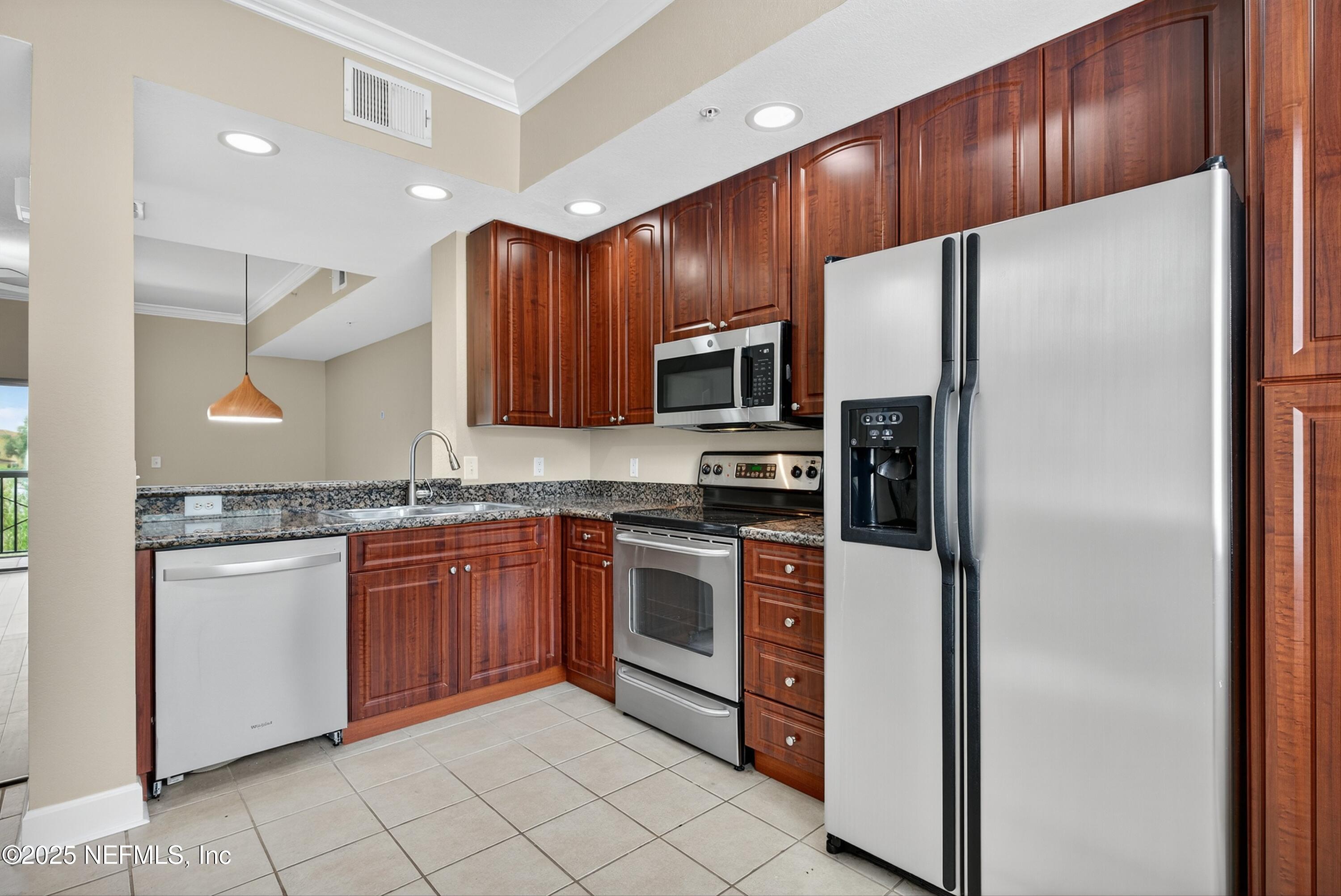 9745 Touchton Road, Unit 1625 Jacksonville, FL 32246 - Photo 31 of 69 a kitchen with stainless steel appliances granite countertop a refrigerator sink and cabinets