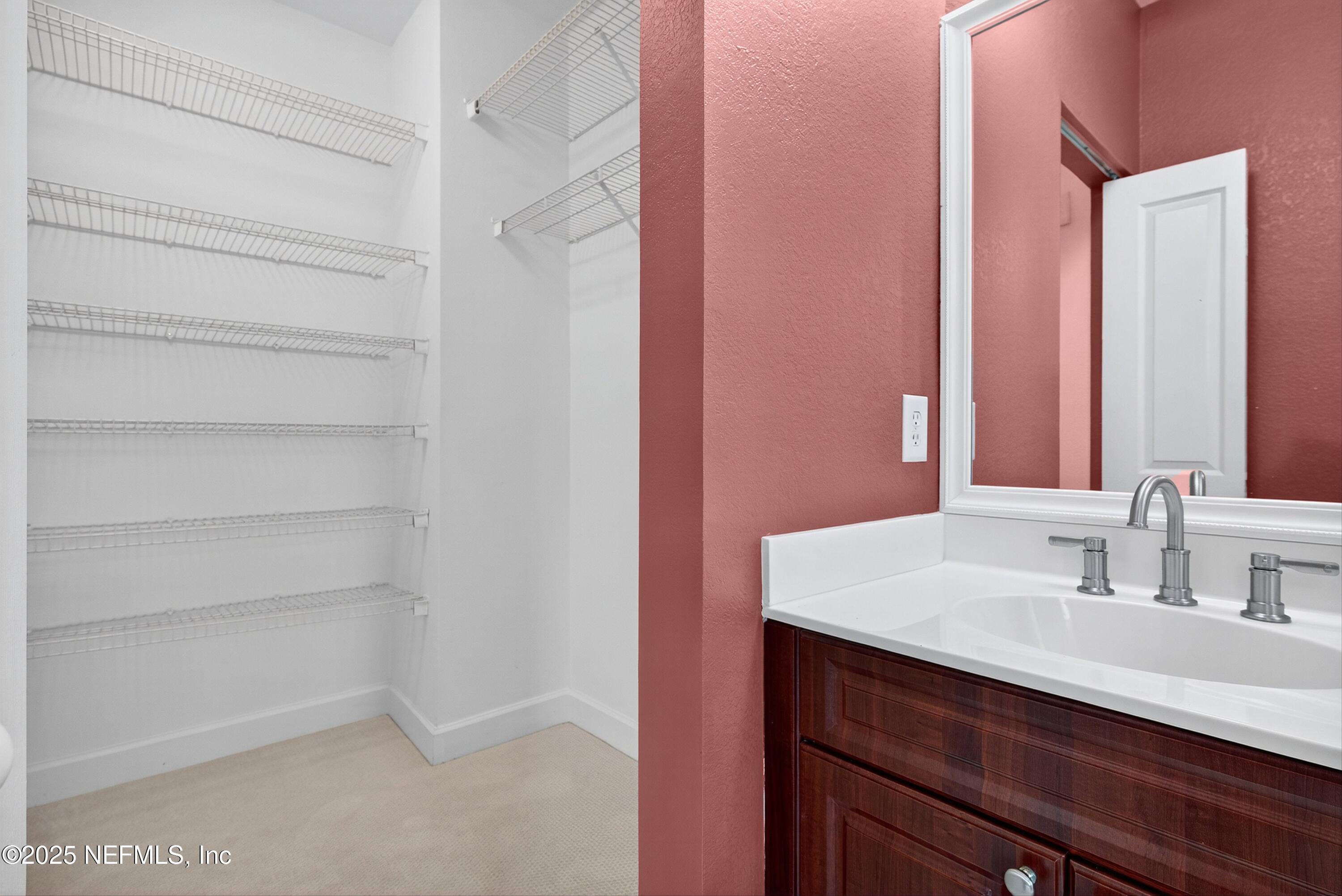9745 Touchton Road, Unit 1625 Jacksonville, FL 32246 - Photo 38 of 69 a bathroom with a sink and a mirror