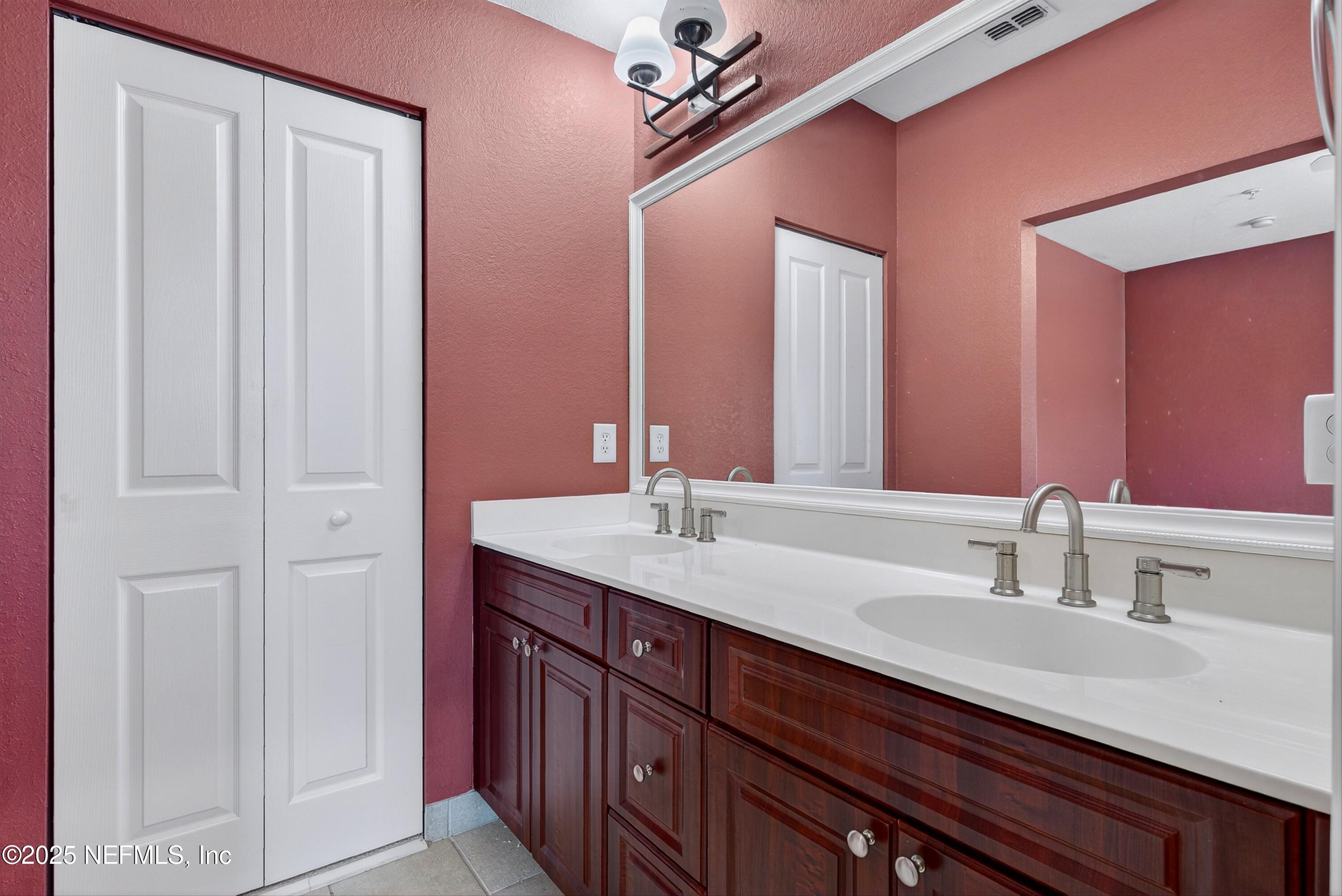 9745 Touchton Road, Unit 1625 Jacksonville, FL 32246 - Photo 39 of 69 a bathroom with a granite countertop sink a mirror and a vanity
