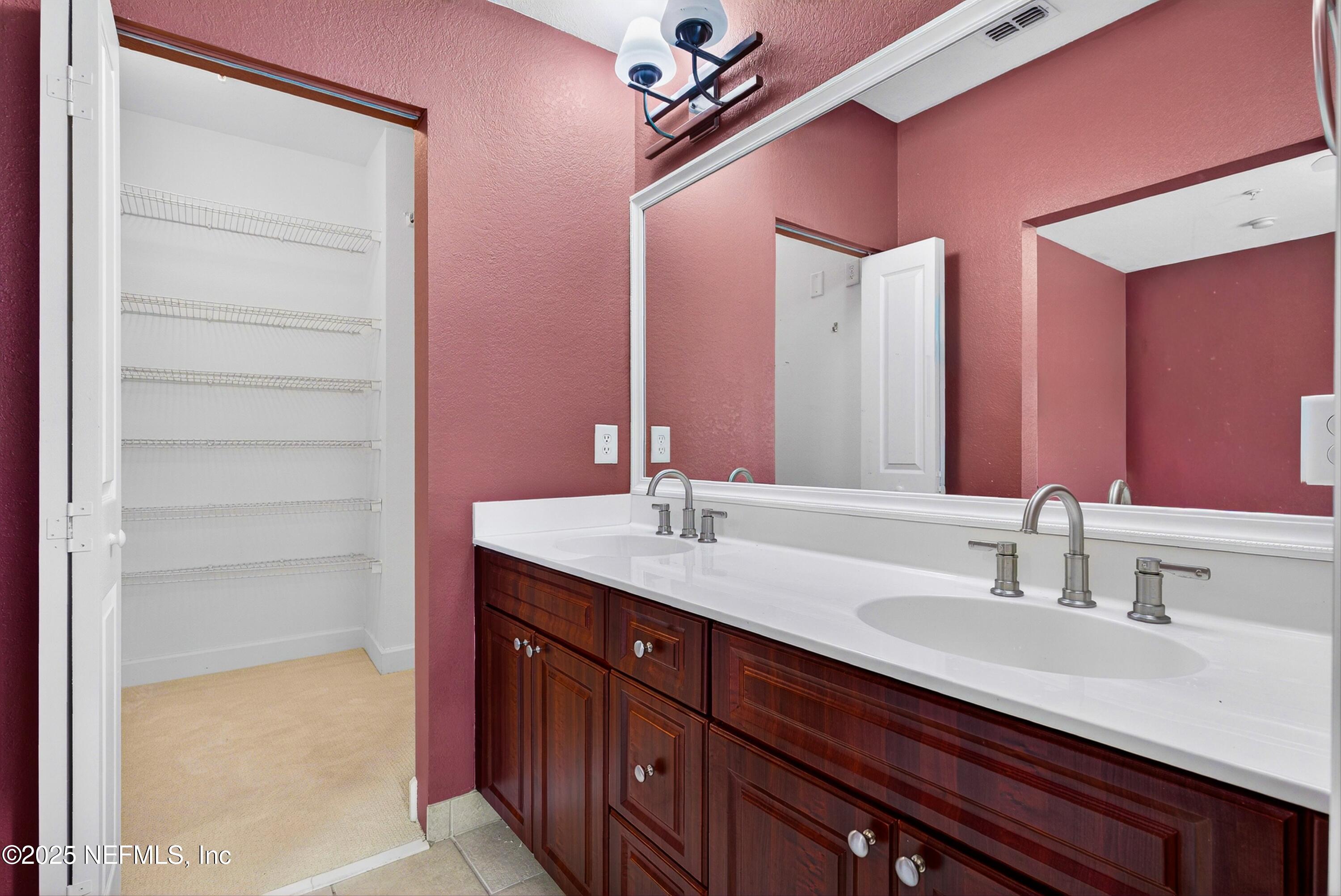 9745 Touchton Road, Unit 1625 Jacksonville, FL 32246 - Photo 40 of 69 a bathroom with a granite countertop sink and a mirror