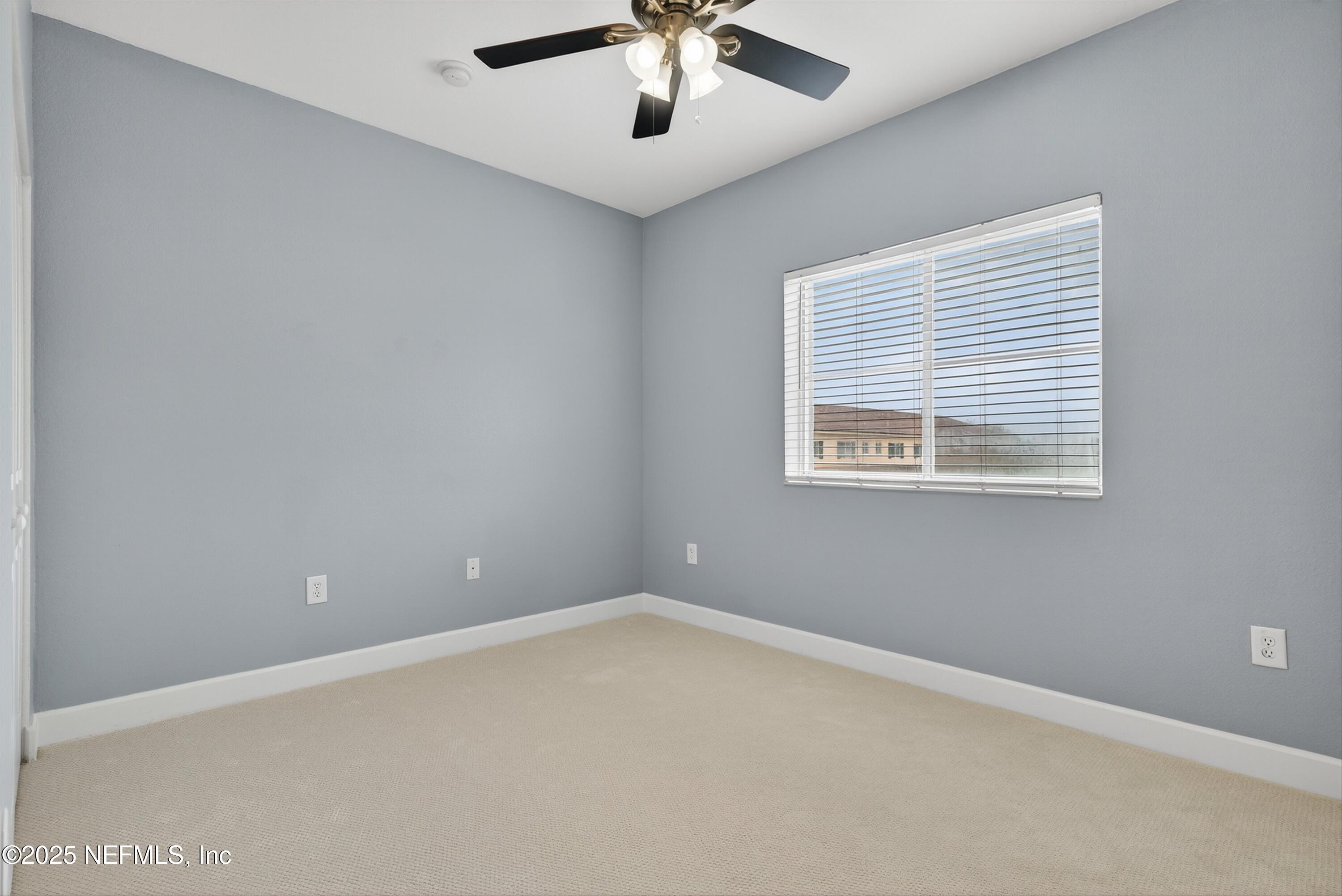 9745 Touchton Road, Unit 1625 Jacksonville, FL 32246 - Photo 41 of 69 an empty room with ceiling fan and window