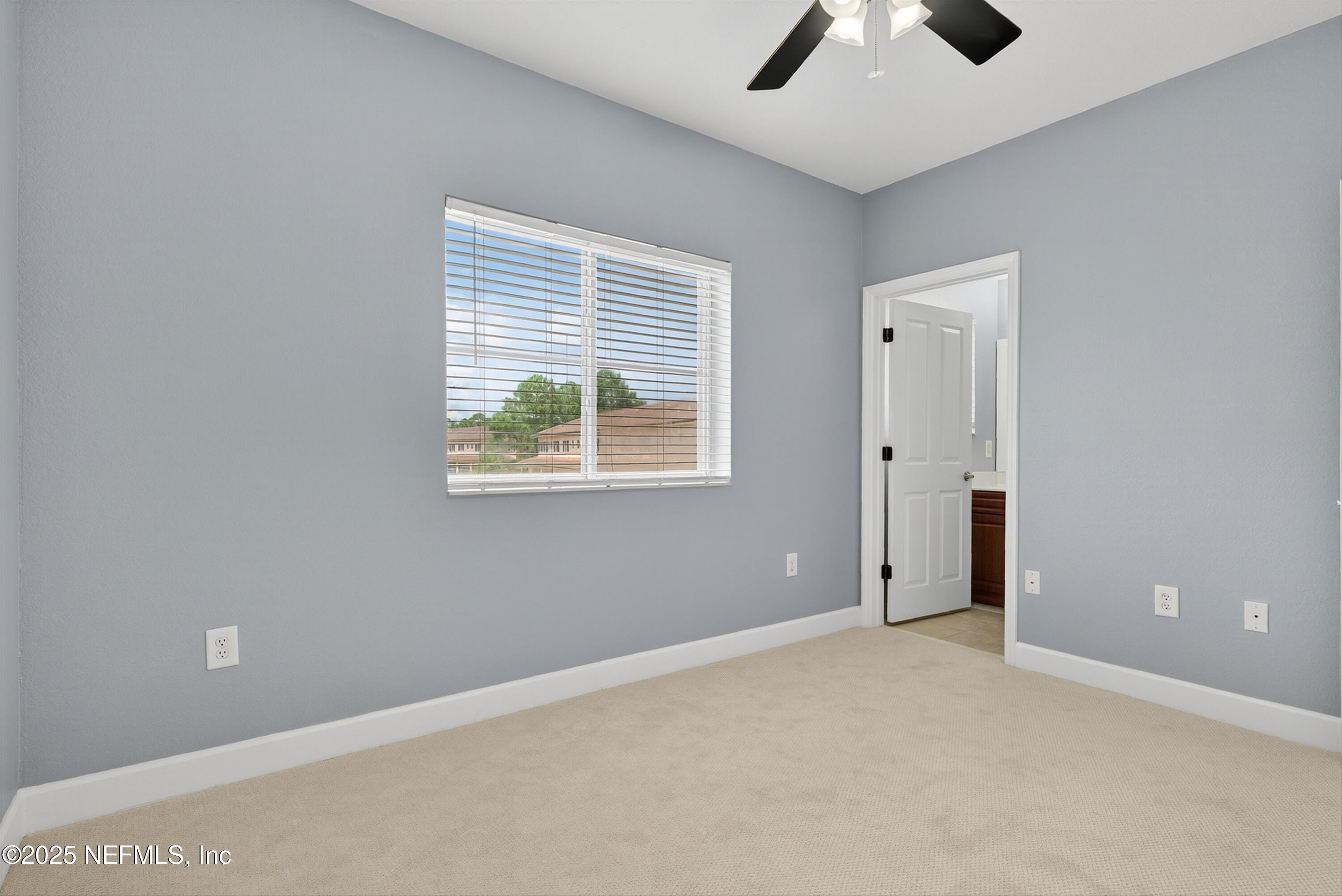 9745 Touchton Road, Unit 1625 Jacksonville, FL 32246 - Photo 43 of 69 an empty room with chandelier fan and windows