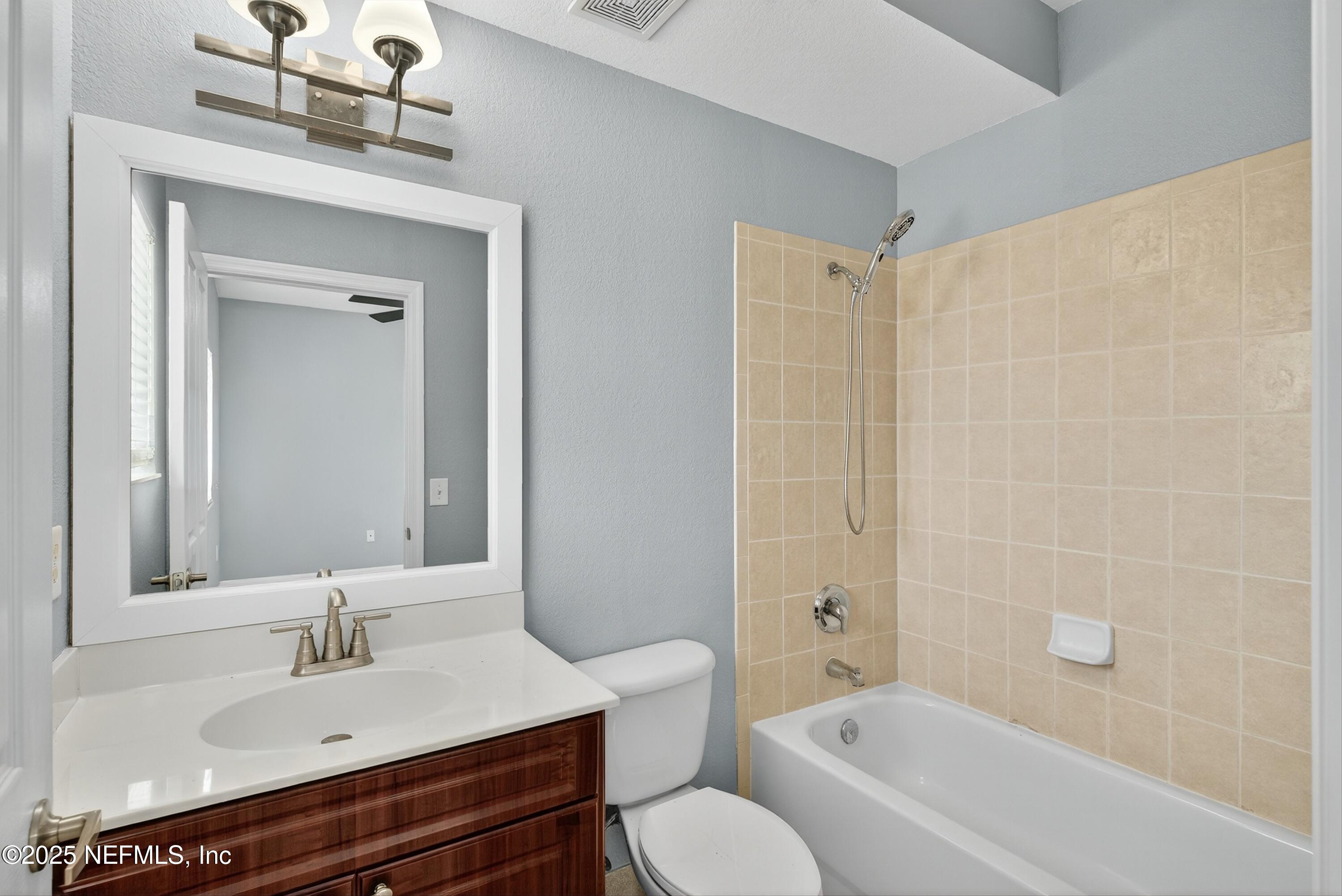 9745 Touchton Road, Unit 1625 Jacksonville, FL 32246 - Photo 45 of 69 a bathroom with a bathtub shower sink vanity and toilet