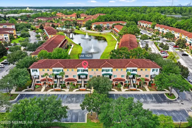 a large kitchen with stainless steel appliances a sink and cabinets