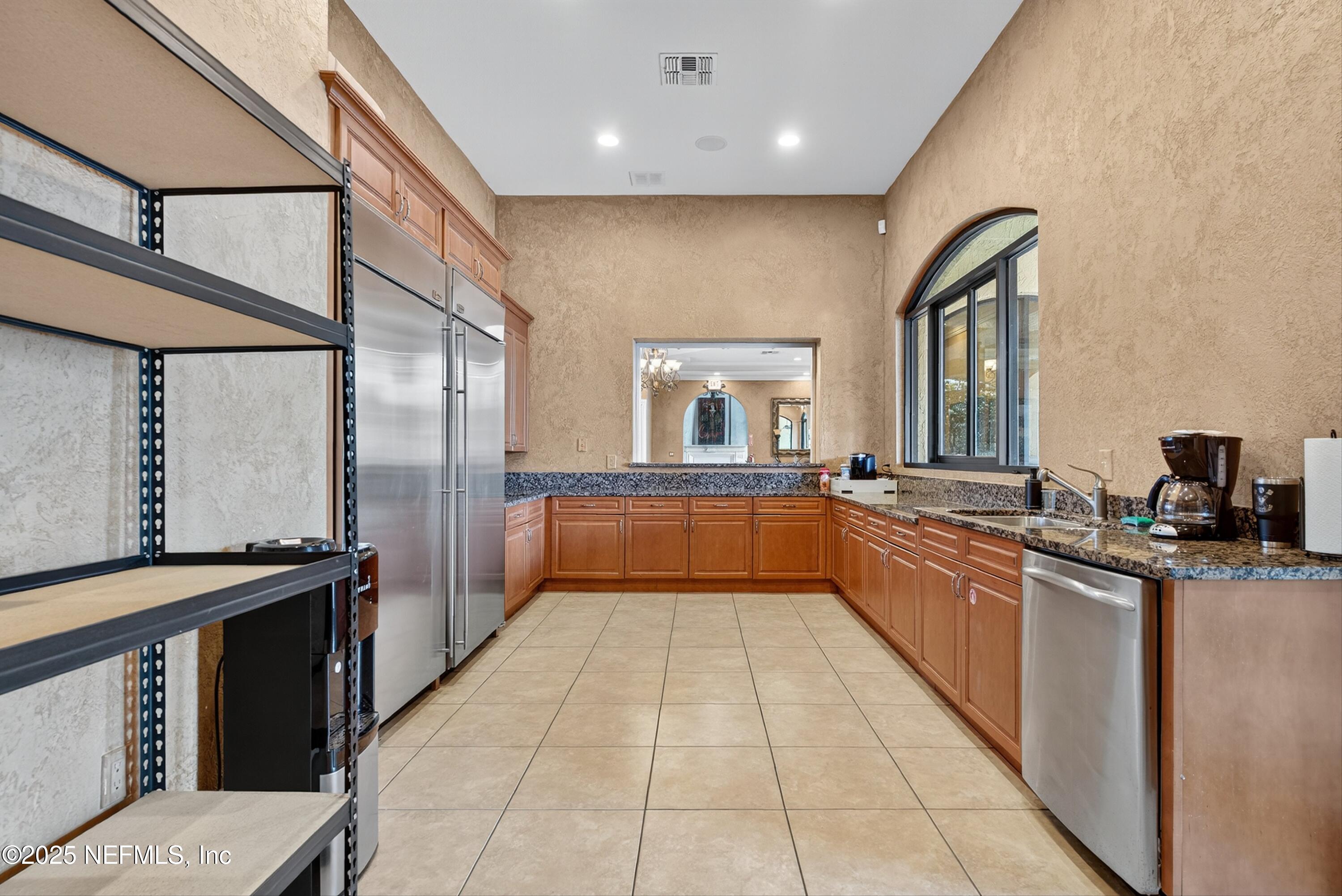 9745 Touchton Road, Unit 1625 Jacksonville, FL 32246 - Photo 66 of 69 a large kitchen with stainless steel appliances a sink and cabinets