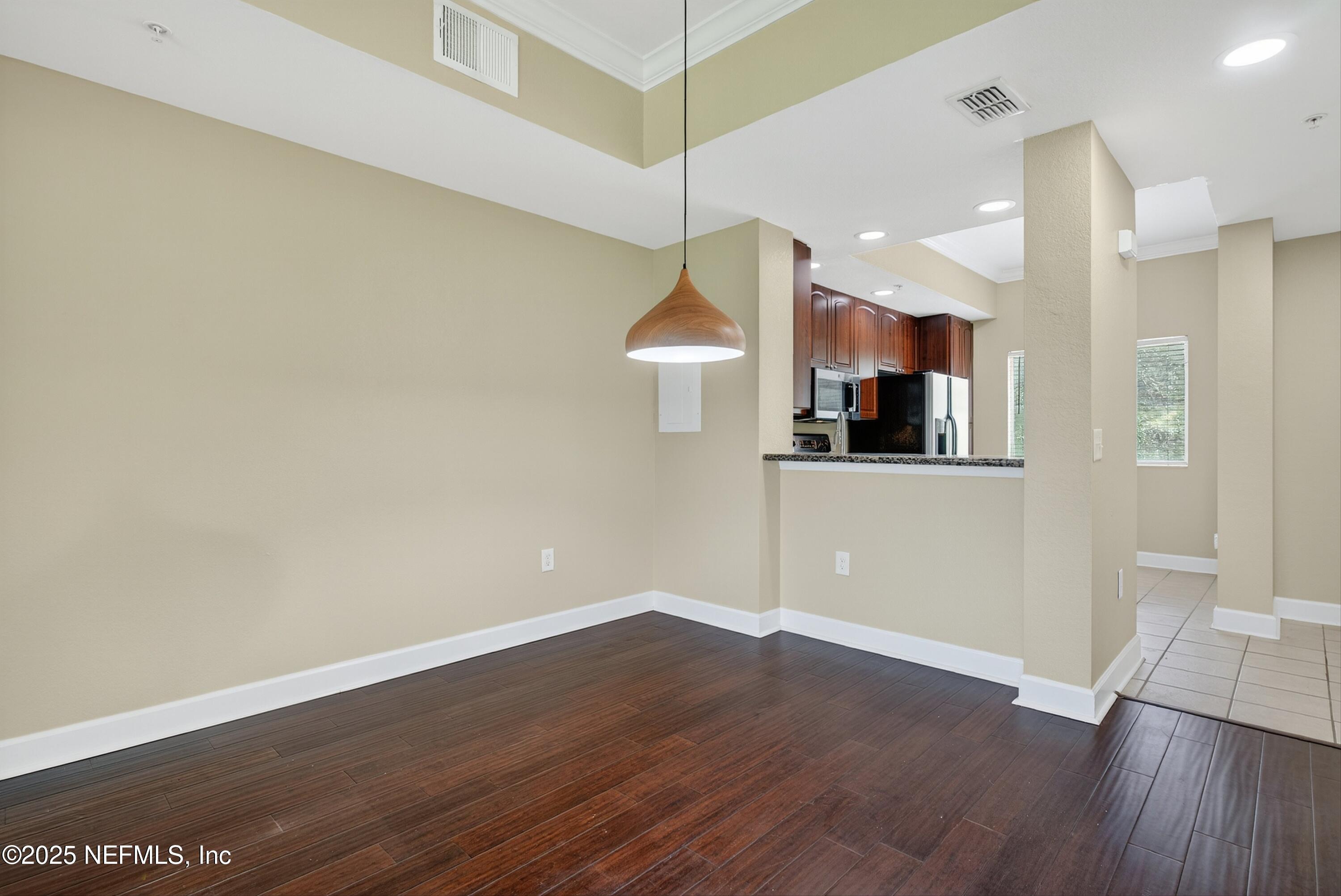 9745 Touchton Road, Unit 1625 Jacksonville, FL 32246 - Photo 9 of 69 a view of a kitchen with wooden floor and a ceiling fan