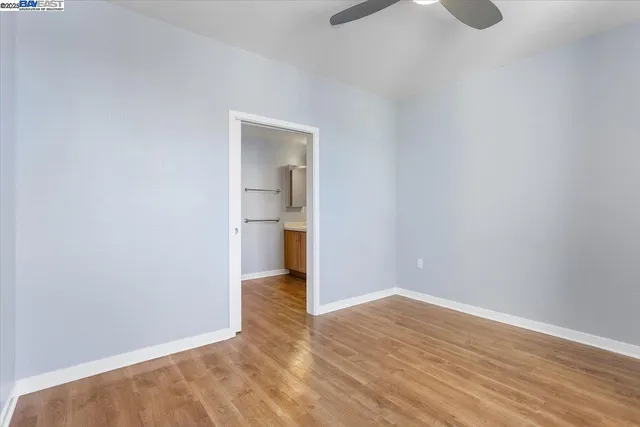 a view of a room with wooden floor and a sink