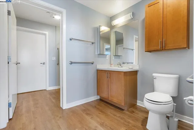 a bathroom with a sink a toilet and mirror