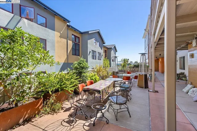a view of a patio with a table and chairs and potted plants