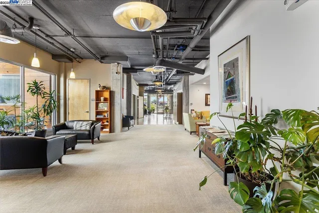 a lobby with furniture and a potted plant