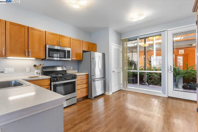 a kitchen with stainless steel appliances a stove sink and microwave