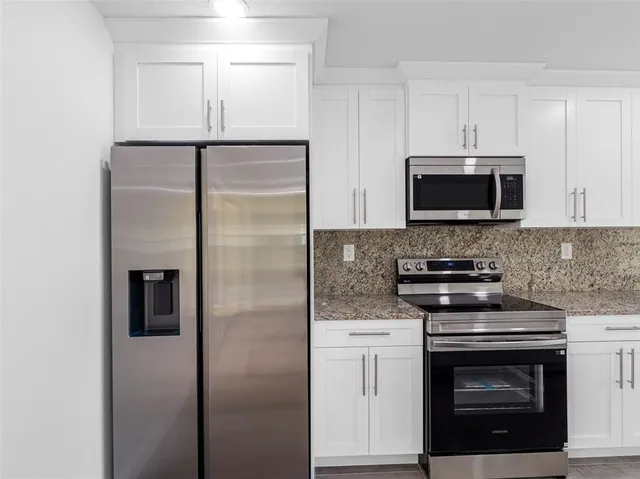 a view of an empty room with a ceiling fan