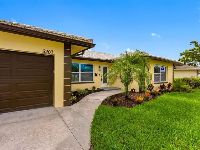 an aerial view of residential houses with outdoor space and swimming pool
