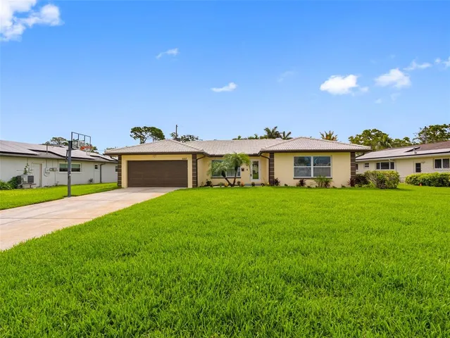 an aerial view of residential houses with outdoor space and swimming pool