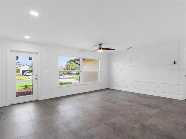 a kitchen with stainless steel appliances granite countertop a refrigerator a sink a stove a microwave and white cabinets