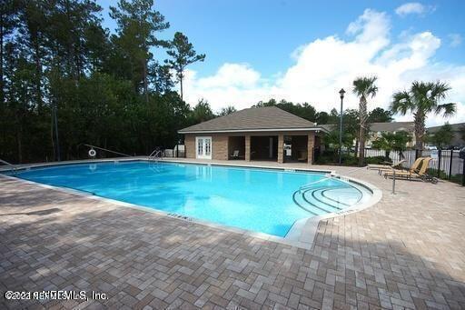 7920 Merrill Road, Unit 1704 Jacksonville, FL 32277 - Photo 11 of 11 a view of a house with swimming pool and porch with furniture