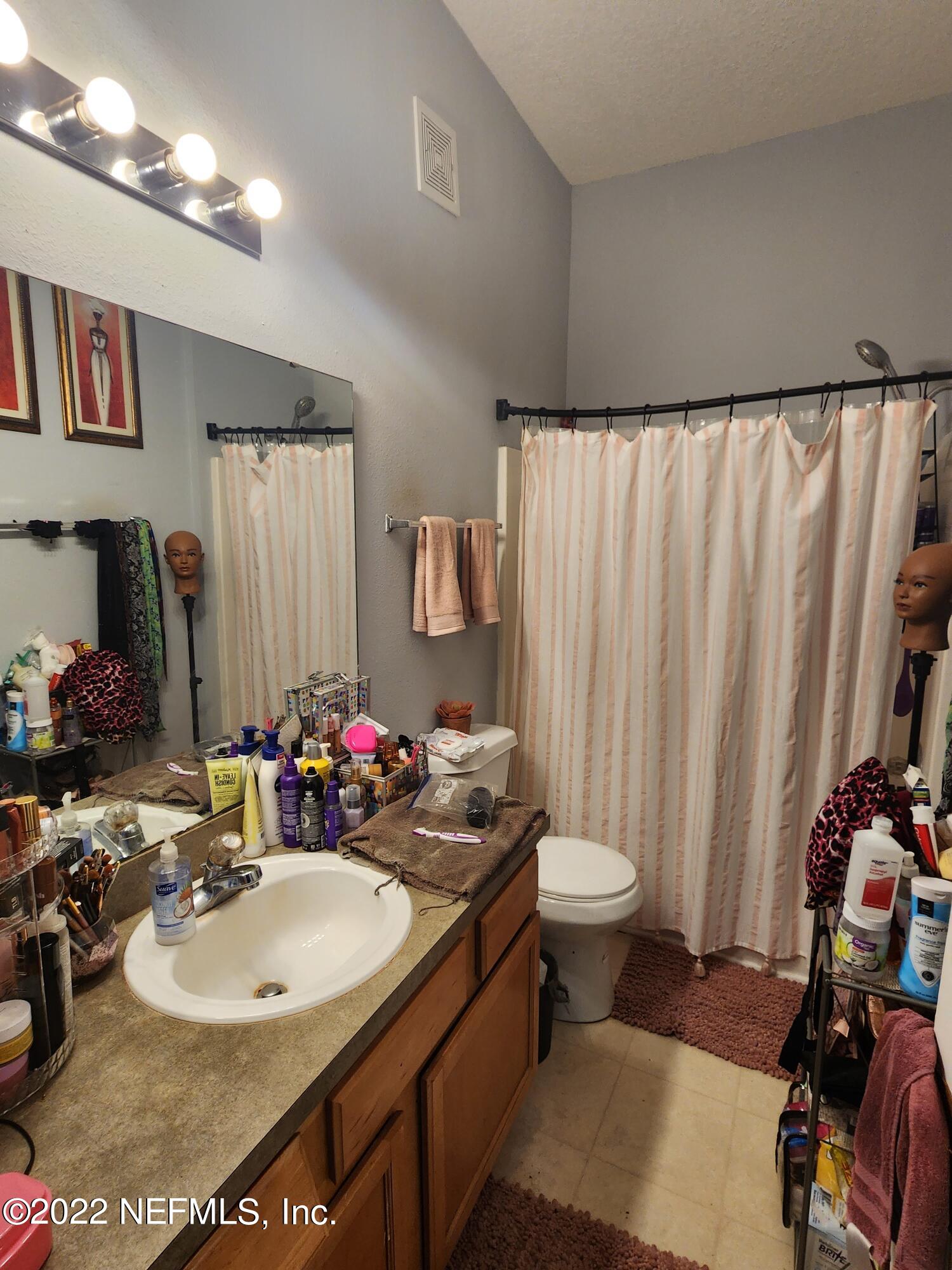 7920 Merrill Road, Unit 1704 Jacksonville, FL 32277 - Photo 7 of 11 a bathroom with a sink toilet and shower