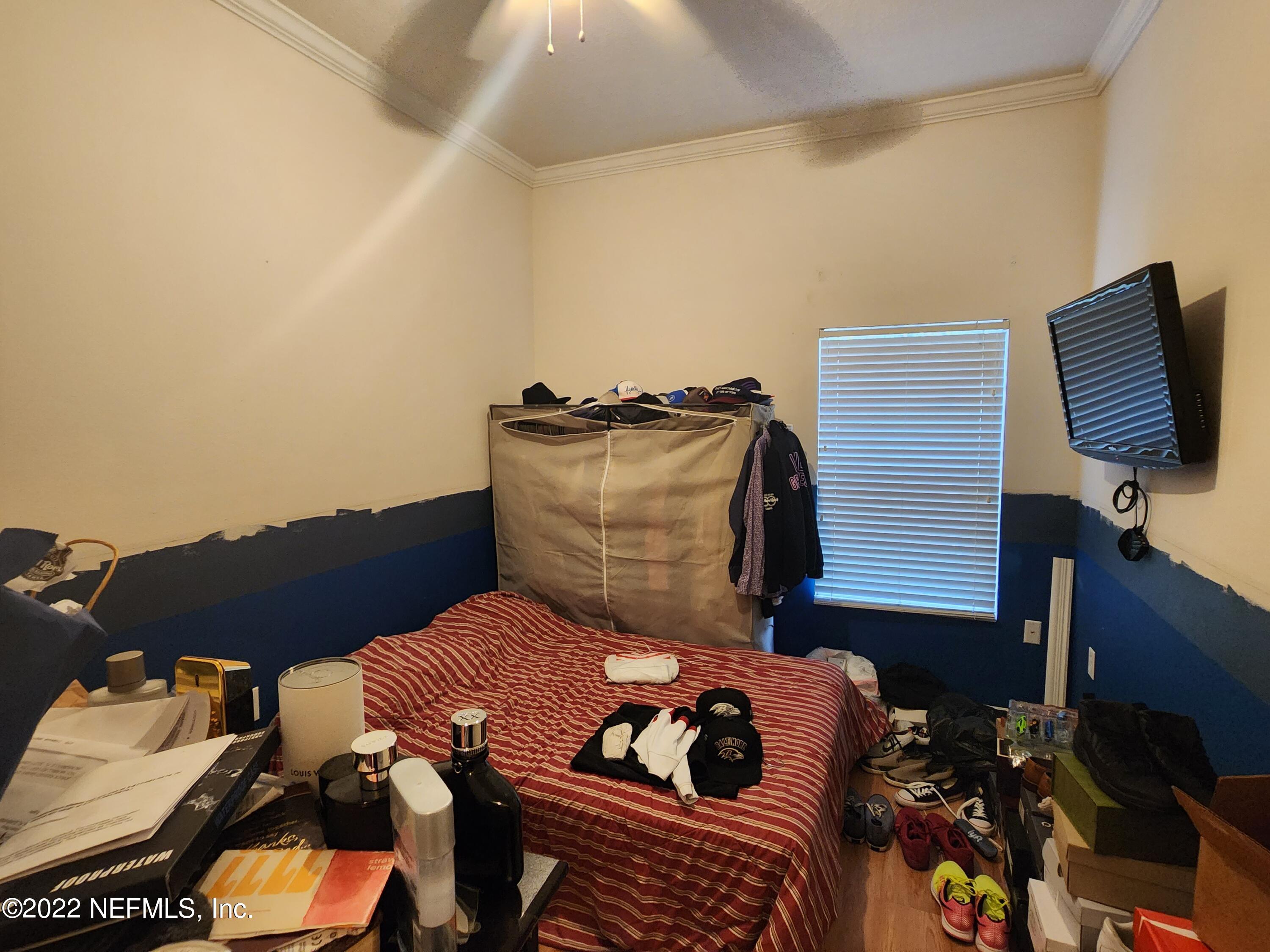 7920 Merrill Road, Unit 1704 Jacksonville, FL 32277 - Photo 9 of 11 a bedroom with a bed and the view of balcony