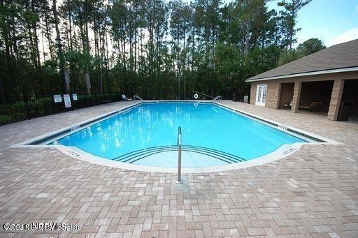 7920 Merrill Road, Unit 1704 Jacksonville, FL 32277 - Photo 10 of 11 a view of a swimming pool with a yard