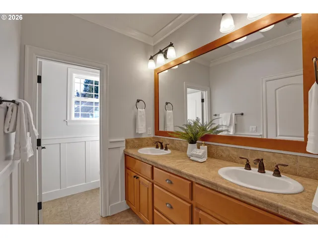a bathroom with double vanity sinks and a mirror
